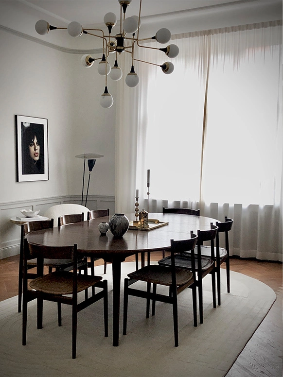 A contemporary rug below a high end dining table in a modern home.